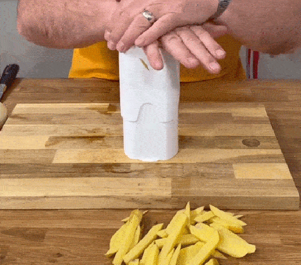 Demonstration of the potato chipper pressing potato through the cutting grid