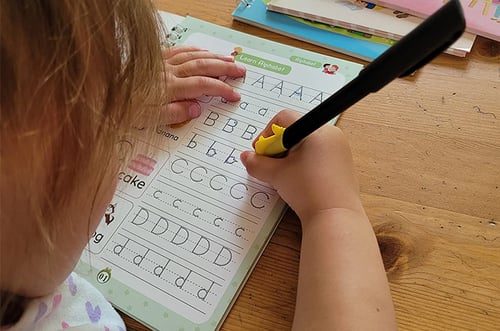 Kids enjoying reusable copybooks