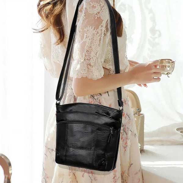 Skuldertaske i blødt læder med flere lommer og stor kapacitet