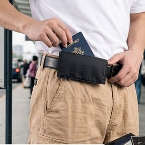 Person wearing a concealed travel waist belt purse