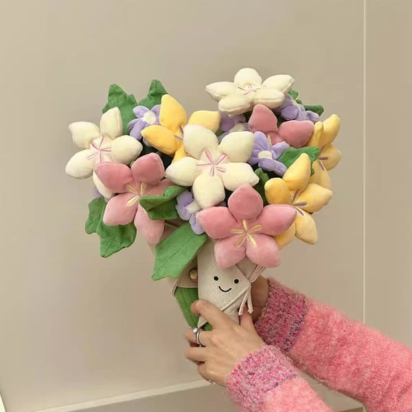 Sødt plysdyr med blomsterbuket