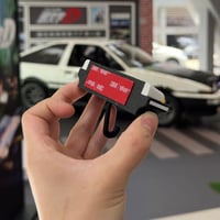 Retro autosleutelhanger met open koplampen
