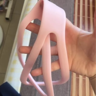 Customer holding a pink Figure 8 resistance band