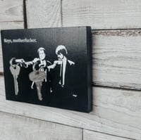 Houten sleutelhanger aan de muur