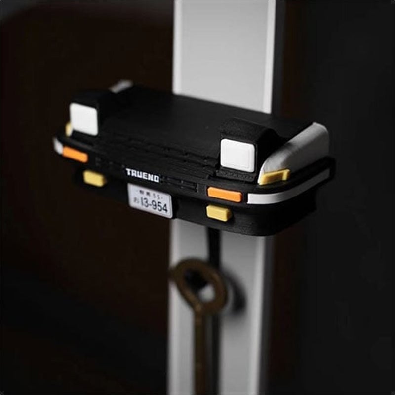 Retro autosleutelhanger met open koplampen
