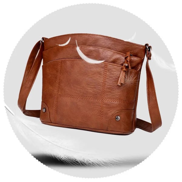 Skuldertaske i blødt læder med flere lommer og stor kapacitet