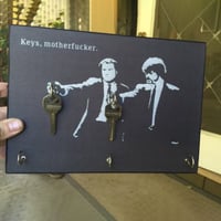 Houten sleutelhanger aan de muur
