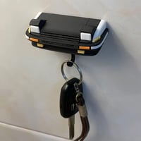 Retro autosleutelhanger met open koplampen