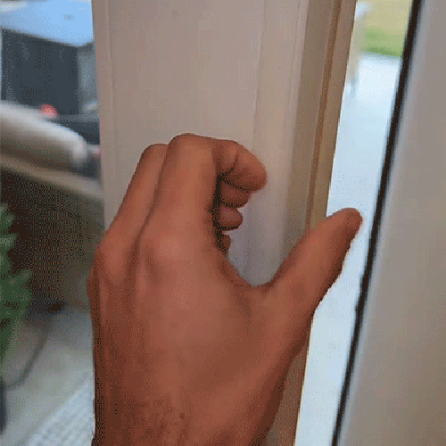 Flexible transparent silicone strip being pressed along a door frame